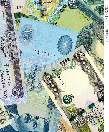 Iraqi dinar paper banknotes pile on table. Iraq IQD currency money bills in big amount. Concept of economics, taxation and banking in Iraq 137158209