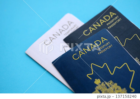 Canadian passports on table close up. Official identification document books for citizens of Canada. Concept of travel and tourism 137158240