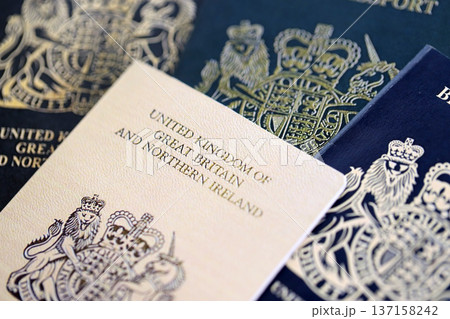 British and Gibraltar passports on table close up. Official identification document books for citizens of United Kingdom. Concept of travel and tourism 137158242