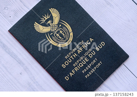 South African passport on table close up. Official identification document book for citizens of South Africa. Concept of travel and tourism 137158243
