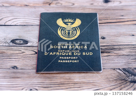 South African passport on table close up. Official identification document book for citizens of South Africa. Concept of travel and tourism 137158246