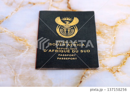 South African passport on table close up. Official identification document book for citizens of South Africa. Concept of travel and tourism 137158256