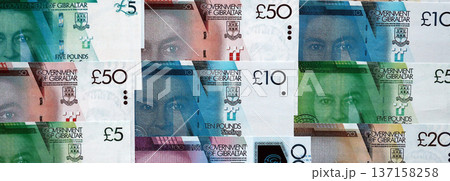 Gibraltar pound paper banknotes pile on table. Gibraltar GIP currency money bills in big amount. Concept of economics, taxation and banking in Gibraltar Gibraltar pound paper banknotes pile on table. Gibraltar GIP currency money bills in big amount. Concept of economics, taxation and banking in Gibraltar 137158258