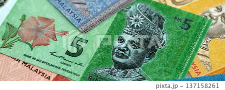 Malaysian ringgit paper banknotes pile on table. Malaysia MYR currency money bills in big amount. Concept of economics, taxation and banking in Malaysia Malaysian ringgit paper banknotes pile on table. Malaysia MYR currency money bills in big amount. Concept of economics, taxation and banking in Malaysia 137158261
