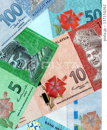 Malaysian ringgit paper banknotes pile on table. Malaysia MYR currency money bills in big amount. Concept of economics, taxation and banking in Malaysia Malaysian ringgit paper banknotes pile on table. Malaysia MYR currency money bills in big amount. Concept of economics, taxation and banking in Malaysia 137158262