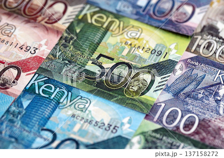 Kenyan shilling paper banknotes pile on table. Kenya KES currency money bills in big amount. Concept of economics, taxation and banking in Kenya Kenyan shilling paper banknotes pile on table. Kenya KES currency money bills in big amount. Concept of economics, taxation and banking in Kenya 137158272