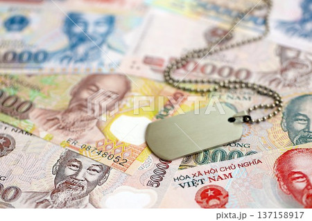 Vietnamese dong currency money bills and military token close up. The concept of army service 137158917