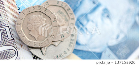 Coins and banknotes of United Kingdom and Great Britain pound currency. UK money close up. Business, economy and finance concept Coins and banknotes of United Kingdom and Great Britain pound currency. UK money close up. Business, economy and finance concept 137158920
