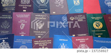 Big amount of passports of various different countries. Covers of expired passports close up. Travel documents for tourism Big amount of passports of various different countries. Covers of expired passports close up. Travel documents for tourism 137158927