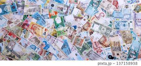 Big amount of money bills of different various currencies and countries. Assortment background of international cash in big pile close up. Currency Exchange concept 137158938