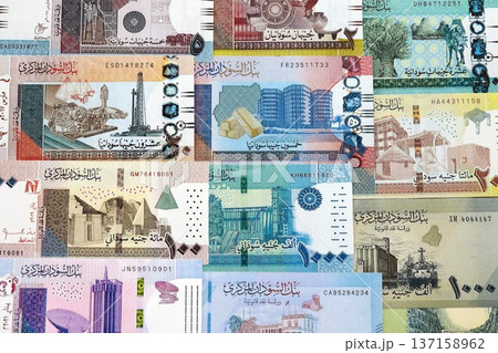 Sudanese pound paper banknotes pile on table. Sudan SDG currency money bills in big amount. Concept of economics, taxation and banking in Sudan Sudanese pound paper banknotes pile on table. Sudan SDG currency money bills in big amount. Concept of economics, taxation and banking in Sudan 137158962