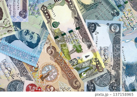 Iraqi dinar paper banknotes pile on table. Iraq IQD currency money bills in big amount. Concept of economics, taxation and banking in Iraq 137158965