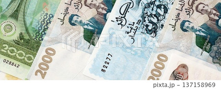 Algerian dinar paper banknotes pile on table. Algeria DZD currency money bills in big amount. Concept of economics, taxation and banking in Algeria 137158969