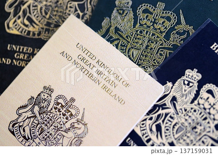British and Gibraltar passports on table close up. Official identification document books for citizens of United Kingdom. Concept of travel and tourism 137159031