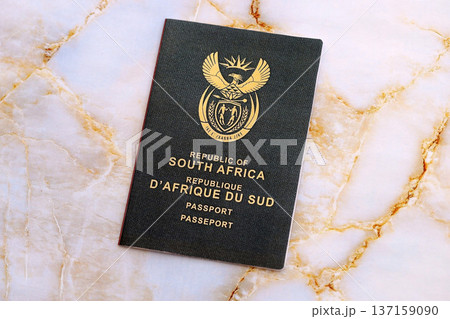 South African passport on table close up. Official identification document book for citizens of South Africa. Concept of travel and tourism 137159090