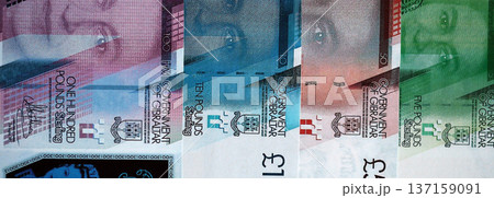 Gibraltar pound paper banknotes pile on table. Gibraltar GIP currency money bills in big amount. Concept of economics, taxation and banking in Gibraltar Gibraltar pound paper banknotes pile on table. Gibraltar GIP currency money bills in big amount. Concept of economics, taxation and banking in Gibraltar 137159091