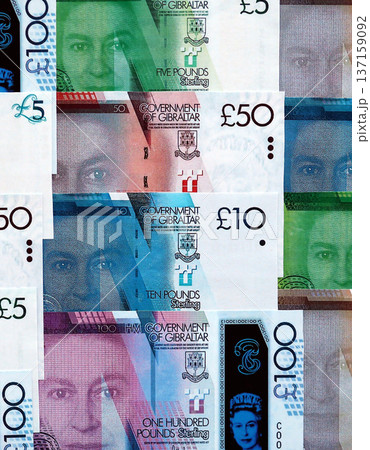 Gibraltar pound paper banknotes pile on table. Gibraltar GIP currency money bills in big amount. Concept of economics, taxation and banking in Gibraltar 137159092