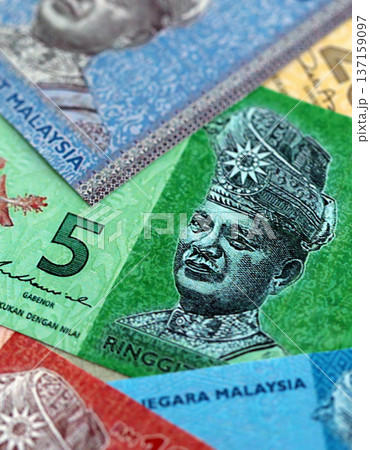 Malaysian ringgit paper banknotes pile on table. Malaysia MYR currency money bills in big amount. Concept of economics, taxation and banking in Malaysia Malaysian ringgit paper banknotes pile on table. Malaysia MYR currency money bills in big amount. Concept of economics, taxation and banking in Malaysia 137159097
