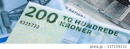 Danish krone paper banknotes pile on table. Denmark DKK currency money bills in big amount. Concept of economics, taxation and banking in Denmark Danish krone paper banknotes pile on table. Denmark DKK currency money bills in big amount. Concept of economics, taxation and banking in Denmark 137159132