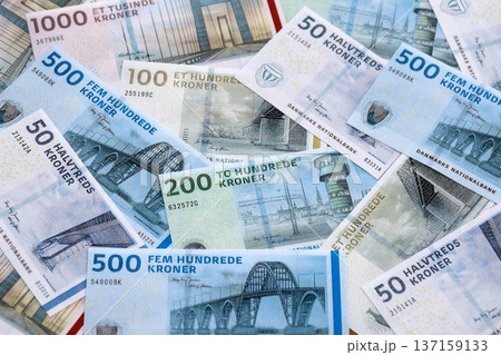 Danish krone paper banknotes pile on table. Denmark DKK currency money bills in big amount. Concept of economics, taxation and banking in Denmark Danish krone paper banknotes pile on table. Denmark DKK currency money bills in big amount. Concept of economics, taxation and banking in Denmark 137159133