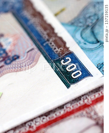 Myanmar kyat paper banknotes pile on table. Myanmar MMK currency money bills in big amount. Concept of economics, taxation and banking in Myanmar 137159135