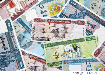 Myanmar kyat paper banknotes pile on table. Myanmar MMK currency money bills in big amount. Concept of economics, taxation and banking in Myanmar 137159136