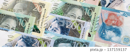 Peruvian sol paper banknotes pile on table. Peru PEN currency money bills in big amount. Concept of economics, taxation and banking in Peru Peruvian sol paper banknotes pile on table. Peru PEN currency money bills in big amount. Concept of economics, taxation and banking in Peru 137159137