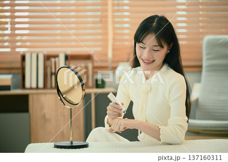 Asian woman applying body cream moisturizing lotion, routine in the morning Asian woman applying body cream moisturizing lotion, routine in the morning 137160311