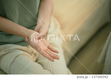 Closeup young woman hand pain her injury pain from cramp, trigger finger, touching massaging, ache joint Closeup young woman hand pain her injury pain from cramp, trigger finger, touching massaging, ache joint 137160342