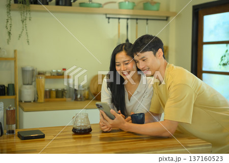 They happy talking with phone , Couple enjoys morning coffee and bonding while having good communication in a relationship They happy talking with phone , Couple enjoys morning coffee and bonding while having good communication in a relationship 137160523