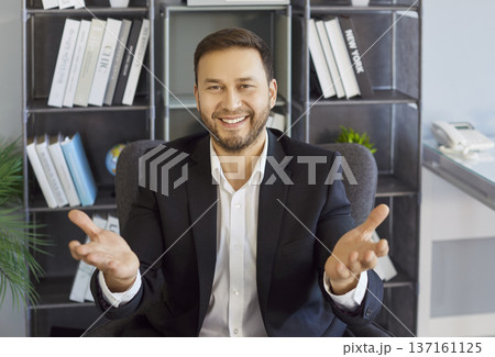 Smiling businessman gesturing to camera during remote office video meeting 137161125