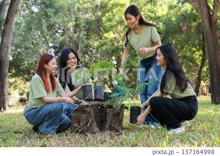 The volunteers show responsibility and teamwork as they collaborate to plant trees and care for plants. Their efforts support sustainability and conservation, helping earth thrive. Volunteer concept 137164998