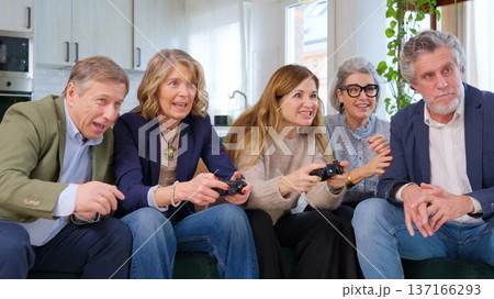 Group of seniors bonding over video games at home Group of seniors bonding over video games at home 137166293