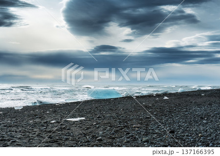 Seascape wave splashing on black sand beach and icebergs in Iceland Seascape wave splashing on black sand beach and icebergs in Iceland 137166395