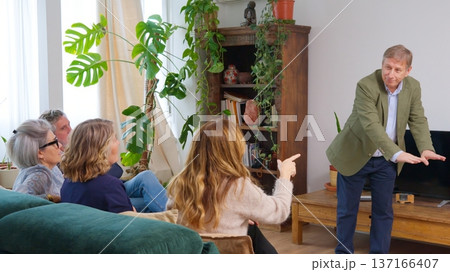 Friends playing movies game, gesturing and having fun at home Friends playing movies game, gesturing and having fun at home 137166407