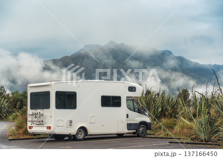 Campervan parked in parking area with misty mountain backdrop in New Zealand Campervan parked in parking area with misty mountain backdrop in New Zealand 137166450