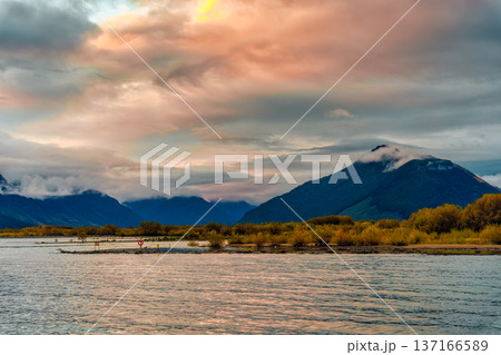 Lake Wakatipu with mountain range and autumn wilderness in the evening at New Zealand Lake Wakatipu with mountain range and autumn wilderness in the evening at New Zealand 137166589