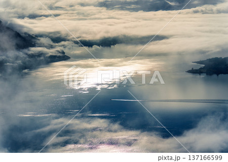 Scenic Lake Wanaka landscape with boat trail in foggy morning Scenic Lake Wanaka landscape with boat trail in foggy morning 137166599
