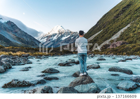 Male tourist taking photo with Mount Cook and water flowing in the evening at Hooker valley track 137166609