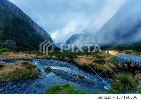 Landscape of Monkey Creek with flowing stream and dramatic mountain in Fiordland, New Zealand Landscape of Monkey Creek with flowing stream and dramatic mountain in Fiordland, New Zealand 137166630