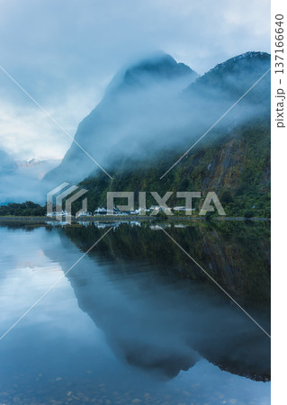 Milford Sound with mountain and ferry port reflection in foggy during morning 137166640