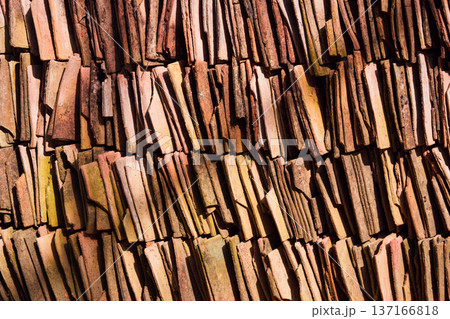 Terracotta clay tiles stacked in sunlight background Terracotta clay tiles stacked in sunlight background 137166818