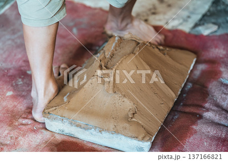 Traditional worker making and processing handmade clay tiles in rustic tile factory process Traditional worker making and processing handmade clay tiles in rustic tile factory process 137166821