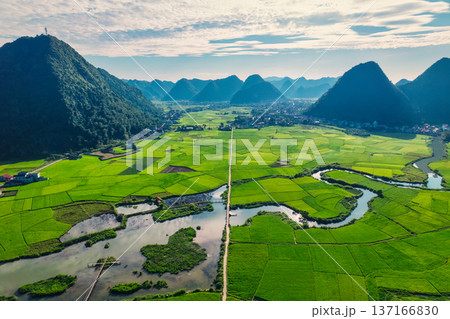 Beautiful Bac Son Valley with lush rice field, mountain range, winding river and rural village at Vietnam 137166830