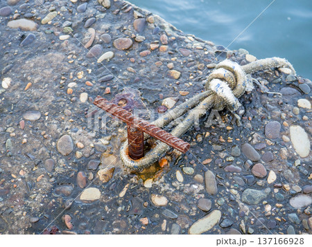 Place for attaching a small boat. Fittings for tying the mooring line. Mounting point. Small bollard on the pier. 137166928