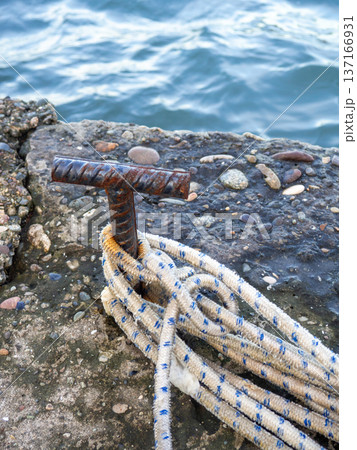 Place for attaching a small boat. Fittings for tying the mooring line. Mounting point. Small bollard on the pier. 137166931