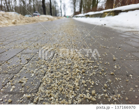 Deicing chemicals on sidewalk in winter. Deicing chemicals on sidewalk in winter. 137166970