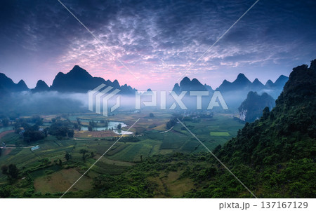 Dramatic sunrise over mountain range with foggy and river flows through in Phong Nam Valley Dramatic sunrise over mountain range with foggy and river flows through in Phong Nam Valley 137167129