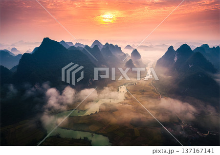 Sunrise over mountain range with foggy on rural village and river flows through in Phong Nam Valley at Vietnam Sunrise over mountain range with foggy on rural village and river flows through in Phong Nam Valley at Vietnam 137167141