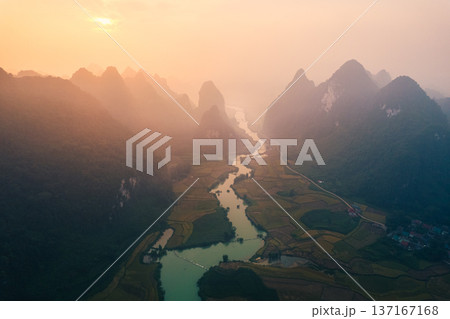 Sunrise over mountain range in foggy on winding river at Phong Nam Valley 137167168